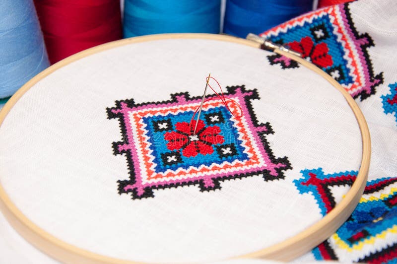 The fabric in the hoop with embroidery. Сross stitch needle embroidery frame ornament on the fabric stock image